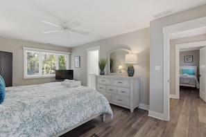 A bedroom with a bed, dresser, TV, and a ceiling fan. - 2425 Inland Harbour at The Sea Pines Resort (Hilton Head Island)
