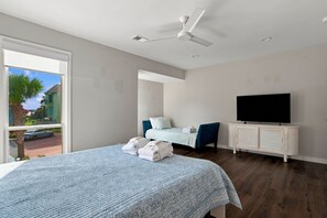 A modern bedroom with a bed, a television, and a ceiling fan. - 726 Schooner Court at The Sea Pines Resort (Hilton Head Island)