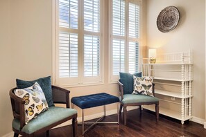A room with two chairs, a bench, and a white shelving unit. - YOUR ARIZONA HOME FOR THE MONTH! (Goodyear)