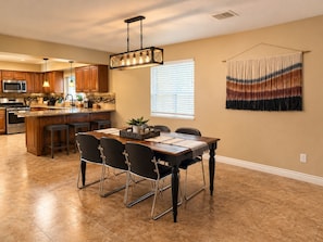 A modern kitchen with a central island, wooden cabinets, and stainless steel appliances. - Relax, Recharge & Play at 3-bedroom Bluewater Bungalow (Lake Havasu City)