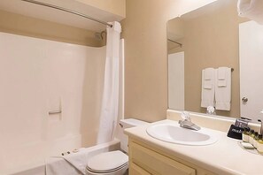 A bathroom with a shower, toilet, sink, and mirror. - Walk-to-Head-Trip Indio Retreat (Indio)