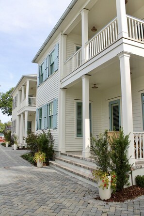 A two-story house with a porch and a driveway. - The Hawthorn House- Walk to King! (Charleston)