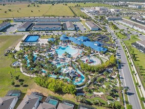 A resort with multiple swimming pools, a central water park, and a variety of buildings. - Modern 6BR Villa Private Pool & Resort Fun (Davenport)