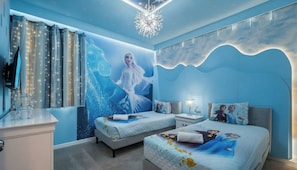 A bedroom with two beds, a nightstand, a dresser, and a wall mural. - This Lakeview Luxury Home & Outdoor Haven (Kissimmee)