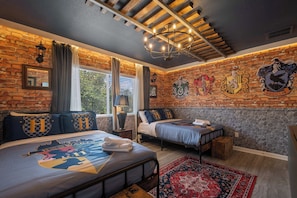 A bedroom with a brick wall, two beds, a chandelier, and Hogwarts-themed decor. - Pool, Hot Tub & Nautical Magic Near Disney (Kissimmee)