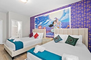 A hotel room with two beds, each with a different patterned pillow, a large wall mural, and a door leading to a bathroom. - 8BR Near Disney Private Pool, spa & Lake View (Kissimmee)