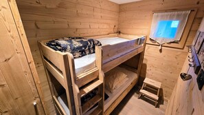 A wooden bunk bed room with a small step ladder and a window with a light fixture. - Chalet "Luna", superbe vue (Bolquère)