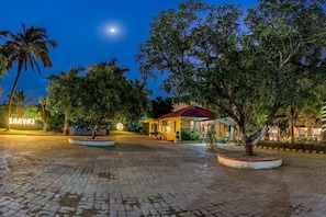 A paved courtyard with a building, trees, and a sign reading 'SAAVAJ'. - Saavaj Resort (Talala)