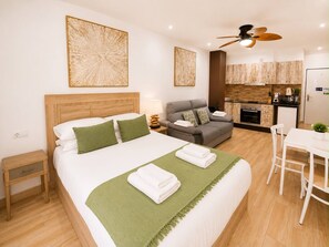 A hotel room with a bed, a sofa, a dining table, and a kitchenette. - 402|Apartment with ocean views|Canteras Beach (Las Palmas de Gran Canaria)