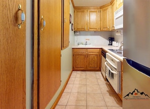 Your fully equipped kitchen features warm wood cabinetry, appliances, and everything you need to prepare meals during your mountain getaway. - Bee Branch 04 SKin-in/out (Sugar Mountain)