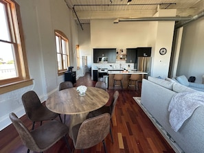 A modern interior with a dining area, kitchen, and living space. - City Views & Comfort | Heart of Downtown Knoxville (Knoxville)