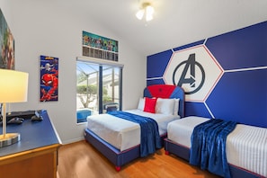 A bedroom with two beds, a desk with gaming equipment, and a large window. - Near Disney + Private Pool 4 BD/ 3BA Indian Creek - 2625 SC (Kissimmee)