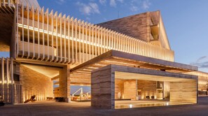 A modern building with a unique architectural design, featuring a prominent overhang and a series of vertical elements. - New Year's Week in Los Cabos: Beachfront Luxury Suite -sleeps up to 4- Two Baths (B.C.S.)