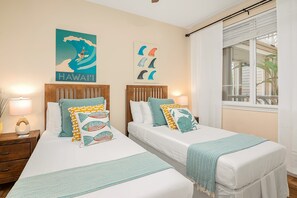 A hotel room with two beds, a view of the outdoors, and two posters on the wall. - 1st floor, no steps, king beds, beach, pool, golf (Waikoloa Village)
