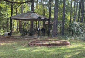 A gazebo with a table and chairs, surrounded by a forest. -  Private 5acre 3bdrm home close  to golfing, fishing, shopping near Augusta Ga (Appling)