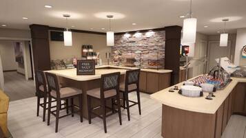 A modern kitchen with a breakfast bar, bar stools, and a stone backsplash.