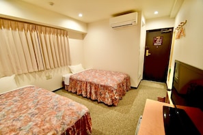 A hotel room with two beds, a TV, an air conditioner, and a door with a sign. - Himeji Ekimae Universal Hotel Minamiguchi (Himeji)