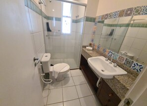 A bathroom with a toilet, sink, and shower. - Atlantic Apart Hotel - Porto das Dunas (Aquiraz)
