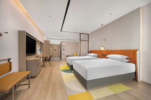 A modern hotel room with a large bed, a desk, a TV, and a sofa. - Home2 Suites by Hilton Hengyang Zhengxiang (Hengyang)