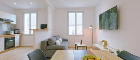A modern apartment with a kitchen, dining area, and living space.