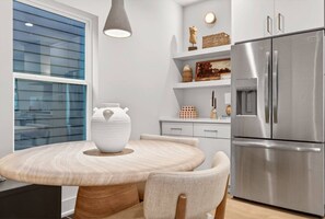 Dining area conveniently located in the kitchen, featuring a table with comfortable seating for five. - Rooftop Patio, 3 Miles to Downtown + Walk to Restaurants (Nashville)