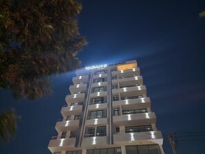 A multi-story building with balconies and a sign reading 'YARAM BUILDING.' - Spacious 3BR Serviced Apartment Near Bole Airport (Addis Ababa)