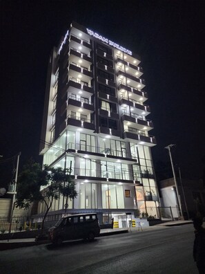 A multi-story building with a sign reading 'YADAM BUILDING' at the top. - Spacious 3BR Serviced Apartment Near Bole Airport (Addis Ababa)