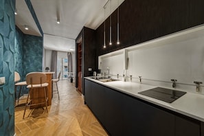 A modern kitchen with a large island, dark cabinetry, and pendant lighting. - Apartment 'Luxury Toledo Blu' with Balcony, Wi-Fi and Air Conditioning (Napoli)