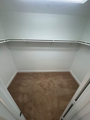 A room with a carpeted floor, white walls, and a ceiling with a skylight. - The Wayne House - Spacious 4BR Retreat Near PGA Frisco & Universal (Aubrey)