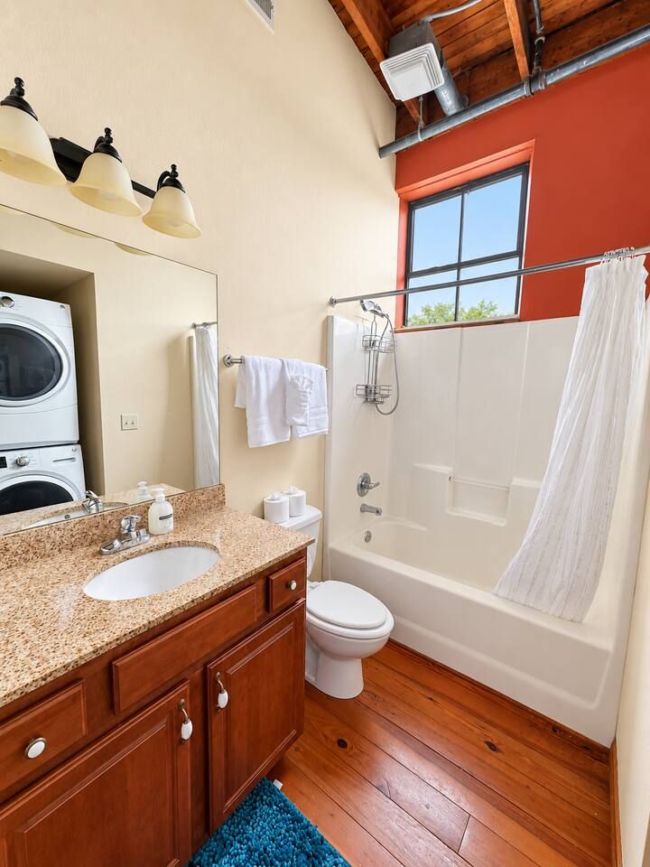 A bathroom with a sink, toilet, and shower.