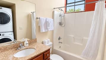 A bathroom with a sink, toilet, and shower.