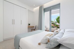A bedroom with a bed, a desk, and a view of the outdoors. - Le Mont Blanc | Large Group Villa Sleeps 13 Guests (Kounoupidiana)