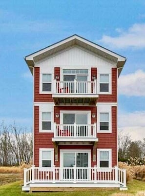 A two-story building with a white balcony on the second floor.