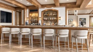 A bar area with a long counter and multiple bar stools. - Resort with 3 bedrooms and fitness room in fabulous Vail (Vail)