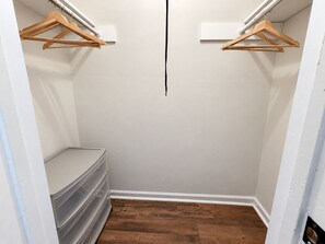 A walk-in closet with wooden hangers on the ceiling, a built-in bench, and a wooden floor. - Pleasant Queen Room & Private Bathroom in Rocky Mount (Rocky Mount)