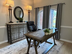 A room with a desk, chair, two lamps, a mirror, and a window with curtains. - Perfect 3-bedroom house in beautiful Memphis for your stay (Memphis)