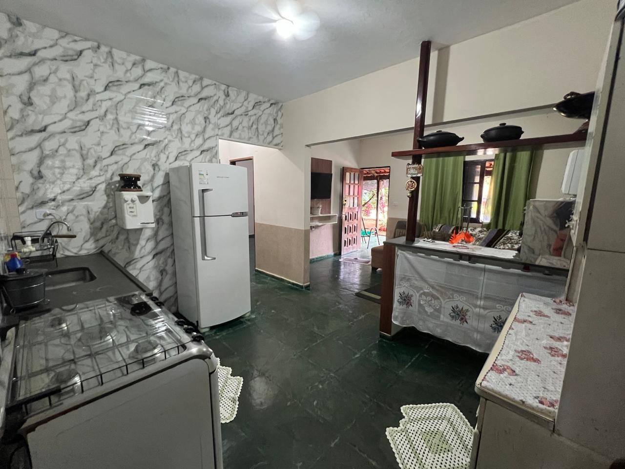 A compact kitchen with a refrigerator, stove, and sink.