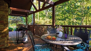 An outdoor patio with a round table, chairs, a grill, and a gas cylinder. - Sunset Ridge View by Avantstay Hot Tub + Game Room Mountain Views Near Dollywood (Sevierville)
