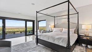 A four-poster bed with a view of a landscape through large windows. - Castle Black by Avantstay Mountain & City Views Hot Tub + Sauna & Gym Trails to Mt Sanitas (Boulder)