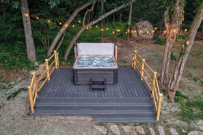 A hot tub on a wooden deck with railings, surrounded by trees and string lights. - Gettysburg Battlefield Queen Room for 3 - Fireplace, Hot Tub & Sauna (Gettysburg)