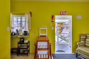 A compact kitchen with a window, a coffee maker, and a sink. - Cozy Caye Caulker Apartment in Central Location w/ AC & Kitchenette | Unit 3 (Caye Caulker)