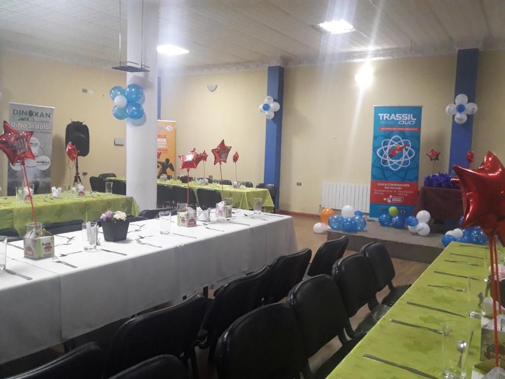 A conference room with tables set for a meeting, balloons, and banners.