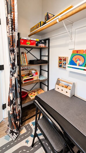 A child's playroom with a loft bed, shelves with toys and books, and a colorful educational poster on the wall. - 5 Mins from Lake/AC/Kids+Pets/Fenced Yard/Toys (Lake Isabella)