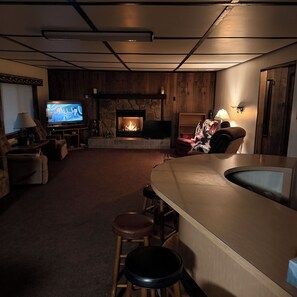 A cozy living room with a fireplace, a television, and comfortable seating. - Cozy 2-bedroom cabin on Solberg Lake perfect for relaxing getaway. (Phillips)