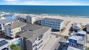 A beachfront residential area with multi-story buildings, a beach, and a clear view of the ocean. - Oceanview Condo - Huge Deck Overlooking Ocean with Pool! (Carolina Beach)