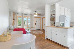 A modern kitchen with white cabinets, a microwave, and a built-in oven. - Cute modern 2 bedroom cottage in Abilene, Texas (Abilene)
