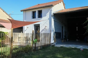 A two-story house with a garage, a fenced yard, and a shaded area. - THE LITTLE KEY TO THE EMERALD (BERGNICOURT)