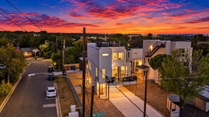 A modern two-story building with a flat roof, a covered patio, and a visible street sign. - Austin Escape w/ Private Patio Near Lady Bird Lake (Austin)