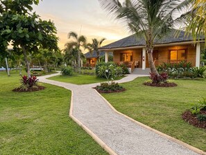 A resort with a paved pathway leading to a building with a thatched roof. - Fantastic deluxe sea view villa with AC in beautiful El Nido (El Nido)