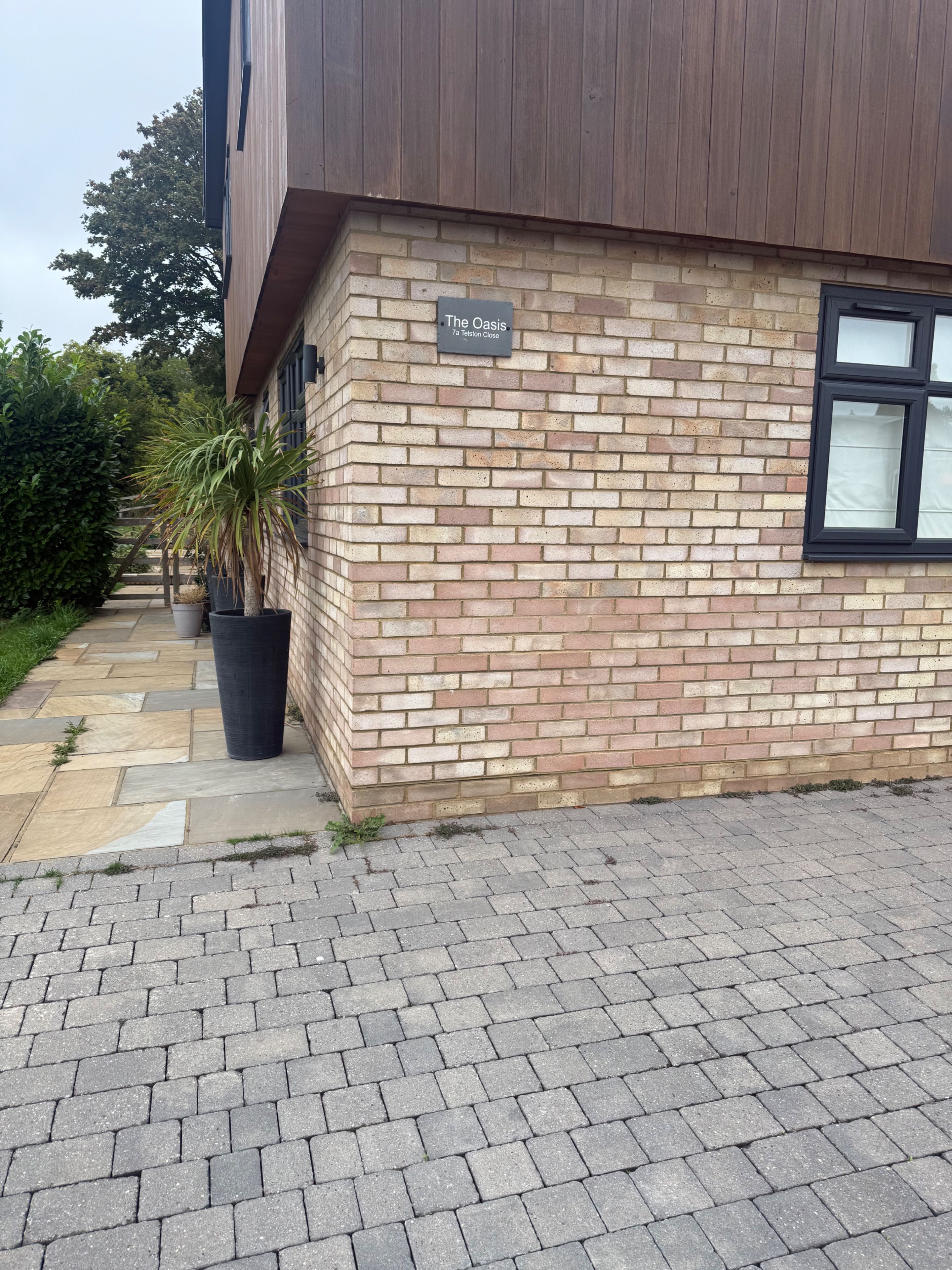 A brick building with a sign reading 'The Oasis 7a Telston Close.'